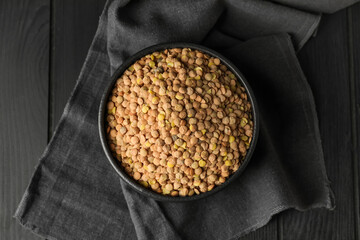 Raw lentils in bowl on table