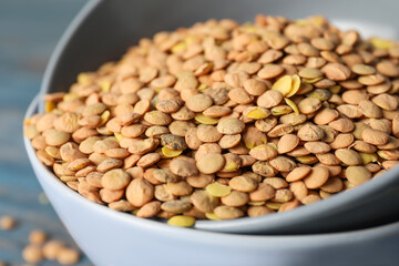 Raw lentils in bowl on table, closeup