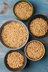 Raw lentils in bowls on table