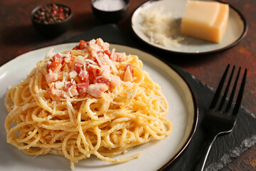 Plate with tasty pasta carbonara on table