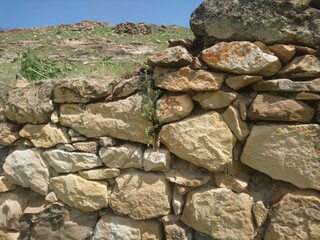 Old walls of mountain stone of an ancient dwelling