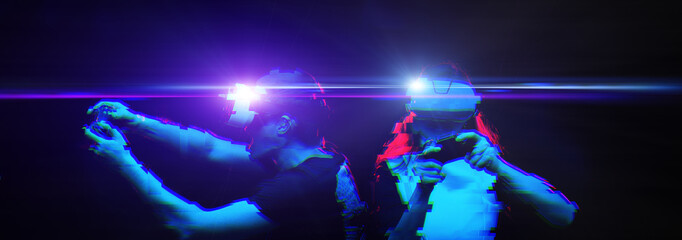 Couple with virtual reality headset are playing game. Image with glitch effect.