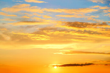 calm sunset sky landscape panorama background. Natural color of blue and yellow evening panoramic cloudscape with setting sun above horizon. Wide view