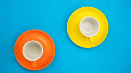 Colorful coffee cup on blue paper background.