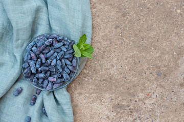honeysuckle berries on a concrete background.