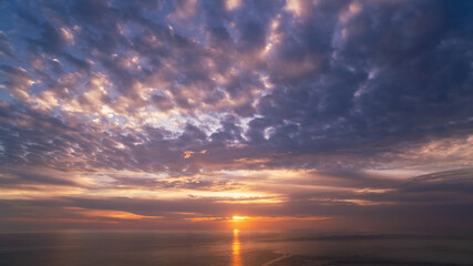 Beautiful light sunset or sunrise over sea scenery nature background with reflex in the water surface Amazing landscape.