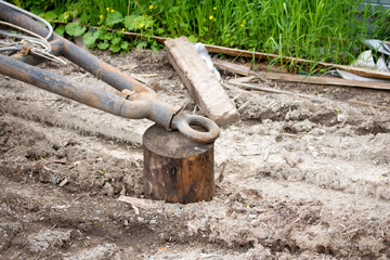 An old rusty trailer and a stump. A trailer for the transport of goods