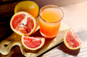 Glass of freshly squeezed grapefruit juice with grapefruit slices. Fat burner