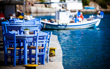 Fototapeta na wymiar Open cafe outdoor restaurant in Greece on sea shore