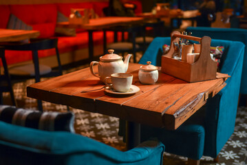 White tea set served on a rustic wooden table in a restaurant. Tea time. Ceramic tea set. Eating out concept.