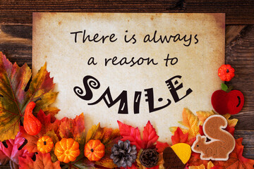 Old Paper With Quote Always A Reason To Smile. Colorful Autumn Decoration Like Pumpkin and Leaves