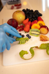 cutting fruit to decorate an ice cream bowl. Craftsmanship. kiwi cut