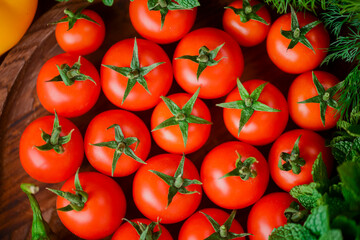 Very fresh tomatoes presented with fresh organic greenery. Vegetables, dill, parsley. Healthy eating.