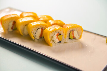 Sushi rolls philadelphia or california with cheddar and creame cheese, with tuna and avocado.