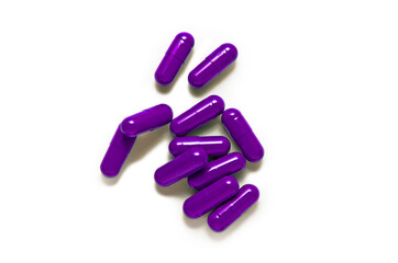 Purple capsule pills isolated on white background