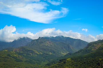 Beautiful Mountainous landscape with green trees, amazing blue sky and mountain range. This picture was captured by a Canon 4D and this place so popular and It's called Riverston/Knuckles Sri Lanka.