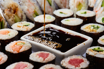 Various kinds of sushi roll set served on cutting board. Japanese food