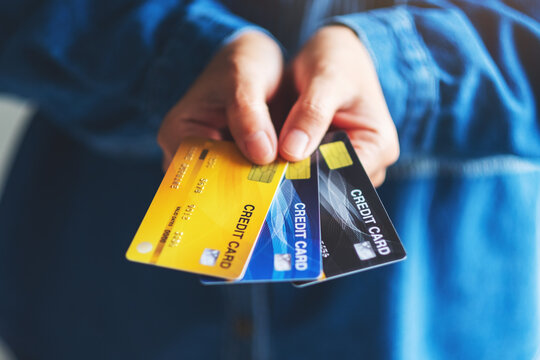 Closeup image of a woman holding and showing credit cards