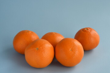 Mandarin orange fruits on light blue background