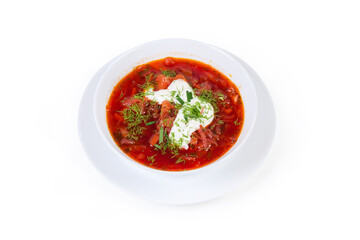 Typical red beetroot borscht seasoned with sour cream in bowl