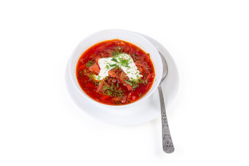 Red beetroot borscht with sour cream in bowl with spoon