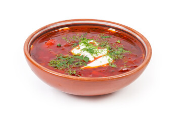 Red beetroot borscht seasoned with sour cream in ceramic bowl
