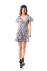 Confident proud young elegant feminine woman walking and marching looking at camera. Full length isolated on white background. 