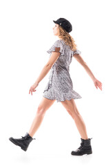 Side view of stylish young woman walking in hurry impressed and interested looking ahead. Full length isolated on white background. 