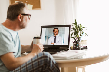 Fototapeta premium Businessman chatting with his colleague. Working at home.