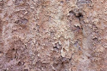 Texture of different layers of clay on the edge of a cliff. Closeup