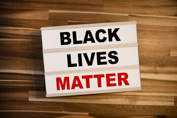 Light box or lightbox with message Black Lives Matter on a wooden table background