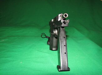 unmanned automatic pistol on a green background