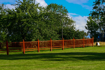 Lidkoping, Sweden A red fence and lawn.