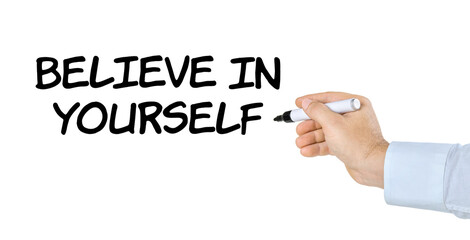 Hand with pen writing Believe in yourself