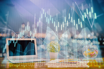 Forex graph hologram on table with computer background. Double exposure. Concept of financial markets.