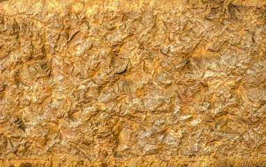 natural background of yellow stone wall with relief