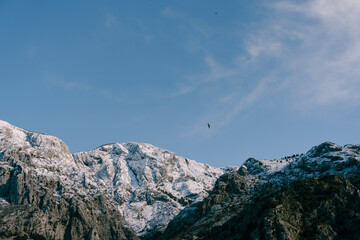 Naklejka na ściany i meble Snow-capped mountain peaks in Boka Kotorska. Winter in Montenegro in Kotor Bay.