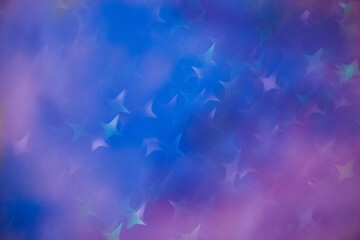 Fototapeta na wymiar Star bokeh on blue with purple background. Cosmos colors background with star shaped bokeh.