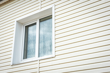Vinyl siding and windows on new house construction.
