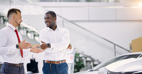 young african businessman ask questions about car presented in dealership, salesman explains and...