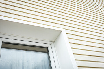 Vinyl siding and windows on new house construction. - obrazy, fototapety, plakaty