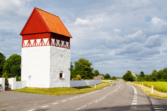 Sankt Bodil Kirke, Bornholm, Denmarm. Old medieval building with half timbering and white chalked base used as a bell tower. The stones in front are tomb stones from the 1600's.
