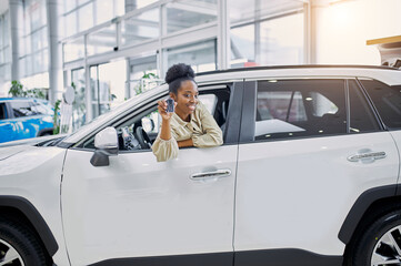 beautiful young african woman fulfilled her dream, bought a car. cars, automobile concept