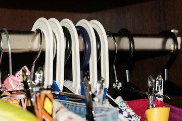 Part of the hangers close-up. Home wardrobe with women's clothing.