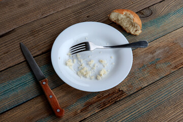 world hunger. plate with leftover food and bread, garbage on the table. The concept of hunger or...