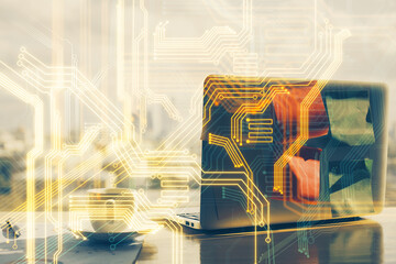 Computer on desktop in office with technology theme hologram. Multi exposure. Tech concept.