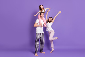 Full length body size view of three person cheerful family dad carrying offspring daughter wearing...