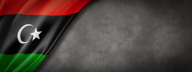 Libyan flag on concrete wall banner