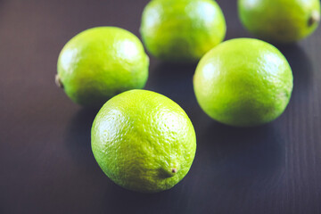 Group of fresh organic limes on a black background