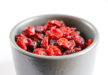 Cranberries in a bowl isolated on white background